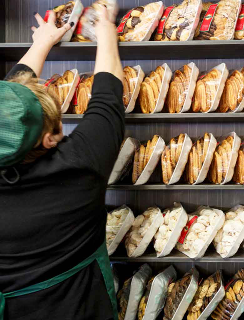 A Corica team member restocking the shelves of the Northbridge shop